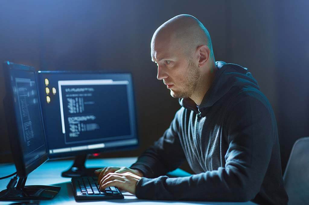 Hacker vor Computer-Monitoren - Sicherheit und Rechteverwaltung